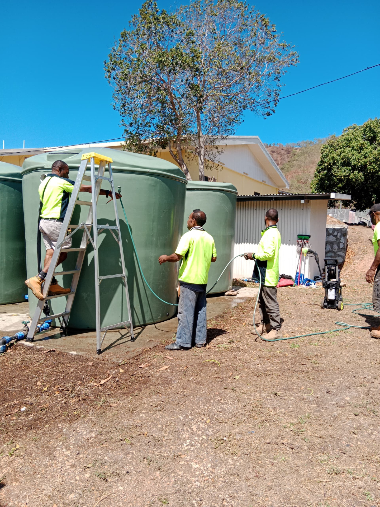 Our crew cleaning commercial water tanks on site
